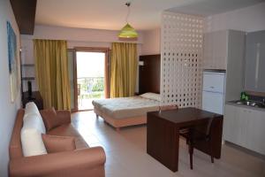 a living room with a couch and a bed at Tsokas Hotel in Finikounta