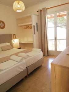 a bedroom with two beds and a large window at Vicky's Panoramic View Apartments in Pelekas