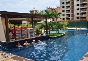 a group of people swimming in a swimming pool at Evian Thermas Residence Caldas Novas in Caldas Novas