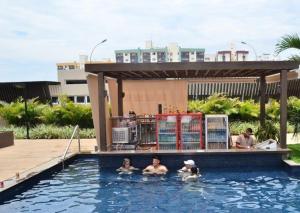 a group of people in a swimming pool at Evian Thermas Residence Caldas Novas in Caldas Novas