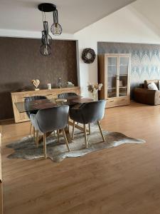 a living room with a dining room table and chairs at Apartman_donovaly_residence in Donovaly