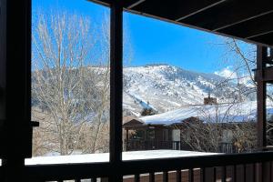 a view of a snow covered mountain from a window at 2404 Pitchfork in Jackson