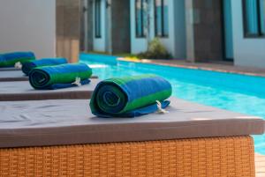 een rij groene opgerolde handdoeken naast een zwembad bij Royal Regantris Trawangan in Gili Trawangan +76 foto's