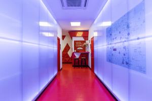 a hallway with a red floor and a red corridor at Art Seven Hostel Capsules in Madrid