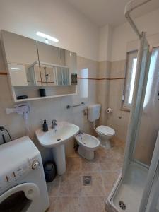 a bathroom with a sink and a toilet and a shower at Family apartment Cathy in Galižana +33 photos