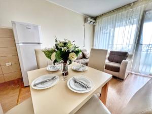 a kitchen and living room with a table and chairs at Adriatique Apartments in Dobra Voda