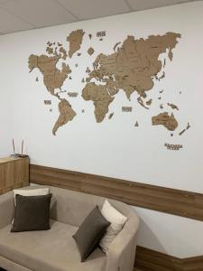 um mapa do mundo numa parede com um sofá em Міні-Готель Білий Квадрат em Kiev