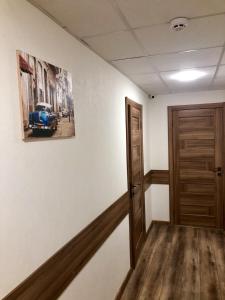 a hallway with a picture of a blue car on the wall at Мини-Отель Белый Квадрат in Kyiv