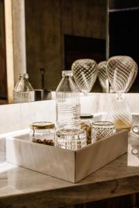 a tray with bottles and glasses on a table at Flavia Hotel in Oaxaca City +9 photos