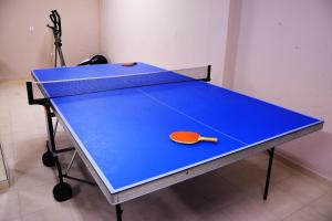 a ping pong table with a tennis racket on it at Tsokas Hotel in Finikounta