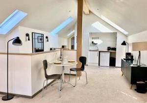 a kitchen with a table and chairs in a room at Woodmill Arches - Designer Barn Conversion for Two in Lindores