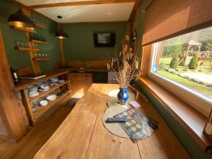 a wooden table in a room with a window at Camping Bušas in Saulkrasti