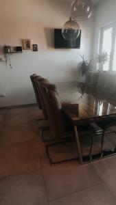 a dining room with a wooden table and leather chairs at Nika in Postira