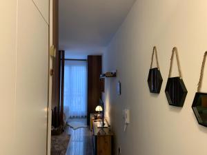 a hallway with two black bags hanging on the wall at Apartment Aria in Travnik