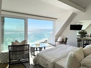 a bedroom with a bed and a view of the ocean at Clifton Ezulwini in Cape Town +47 photos