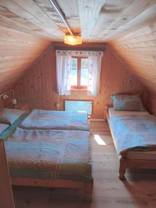 a bedroom with two beds in a attic at Mountain house MINKA in Srednja Vas v Bohinju