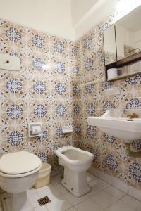 a bathroom with a toilet and a sink at Argentino Hotel in Mar del Plata