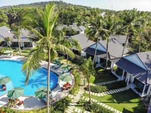 an aerial view of the resort with a pool and palm trees at Kingo Retreat Resort in Phú Quốc