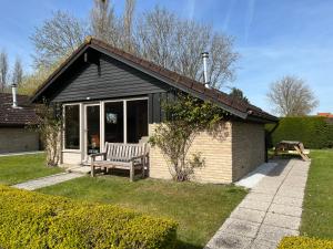 a house with a bench in a yard at Vakantiehuis Gertrude in Middelkerke
