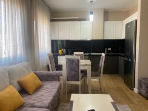 a living room with a couch and a table and a kitchen at Tirana New Bazaar- Apartment no-1 in Tirana