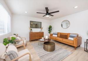 a living room with a couch and a ceiling fan at Mid Century Modern Boise-River Bungalow w/ Hot Tub in Boise