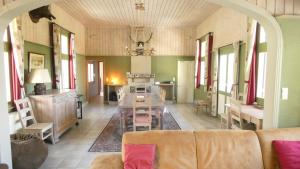 a living room with a couch and a table at Le Chaumont in Theux