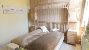 a bedroom with a large bed in a room at Le Chaumont in Theux