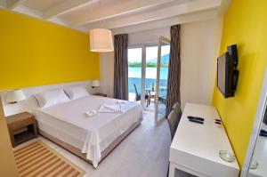 a hotel room with a bed and a view of the ocean at Apartments Bojana in Tivat