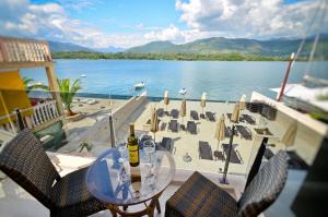 a table with two bottles of wine and chairs on a boat at Apartments Bojana in Tivat