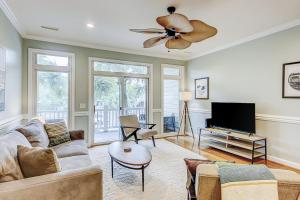a living room with a couch and a ceiling fan at Turtle Bay 5 in Folly Beach