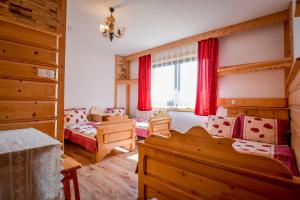 a bedroom with two beds and a window at U Gronikowskich in Zakopane