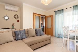 a living room with a couch and a table at Casa do Afonso Cabanas Beach in Cabanas de Tavira