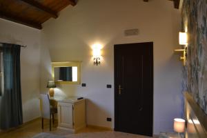 a room with a black door and a desk and a lamp at Duomo Apartments Cefalù in Cefalù