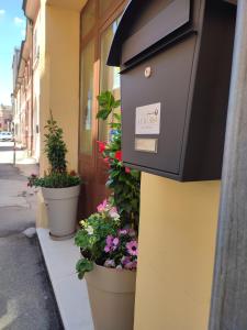 a mail box on the side of a building with flowers at Casa Aurora in Ravenna