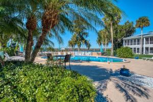 a resort with a pool and palm trees and a building at River Bend B212 in Welaka