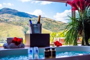 a bottle of wine in a bucket next to a swimming pool at Balneário do Lago Hotel in Capitólio