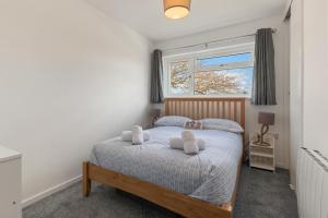 a bedroom with a bed with two pillows on it at Coedrath Park 20 - Modern Apartment, Close to the Beach in Saundersfoot