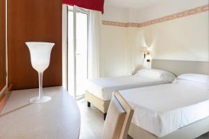 Postel nebo postele na pokoji v ubytování Hotel Bikini