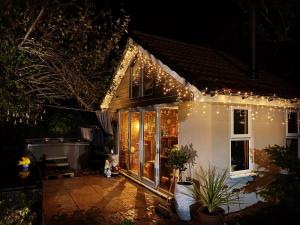 a house with christmas lights on it at night at One ninety Boutique Accommodation in Burnham on Sea