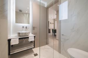 a bathroom with a sink and a mirror at Villa De Reve in Laganas
