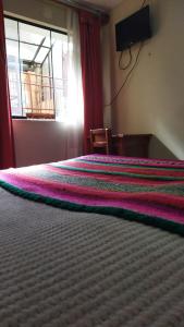 Posteľ alebo postele v izbe v ubytovaní Hostal los Uros