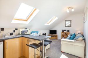 a kitchen with a table and a couch in a room at The Litte Hideaway in Saint Columb Minor