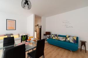 a living room with a blue couch and a table at Apartment Brandesa in Korčula