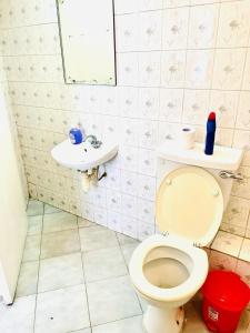 a bathroom with a toilet and a sink at Swan Lakeview 2 Apartment with WiFi,Netflix Free Parking,Sunset,Lakeview in Kisumu
