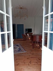 an open door to a living room with a pool table at Château de Perpezat in Apchat