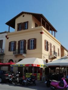 a large building with motorcycles parked in front of it at Aegina Port Apt 4 in Aegina Town +21 photos