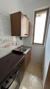 a small kitchen with a sink and a window at A'mare in Siculiana Marina