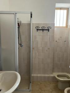 a bathroom with a shower and a toilet and a sink at A'mare in Siculiana Marina