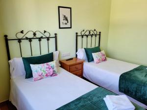 two beds sitting next to each other in a bedroom at Vilariño Moscoso in Arzúa +27 photos