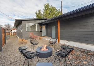 a patio with chairs and a fire pit in front of a house at Mid Century Modern Boise-River Bungalow w/ Hot Tub in Boise